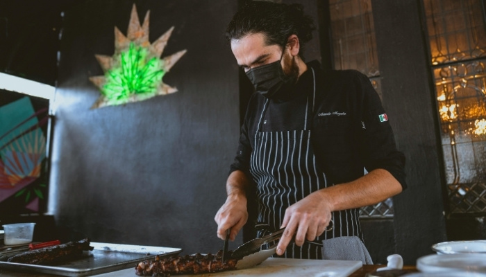 Chef slicing smoked meat at a Toronto BBQ event