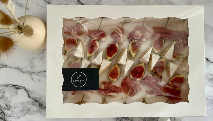 Catering delivery logistics and labeled packaging for offices