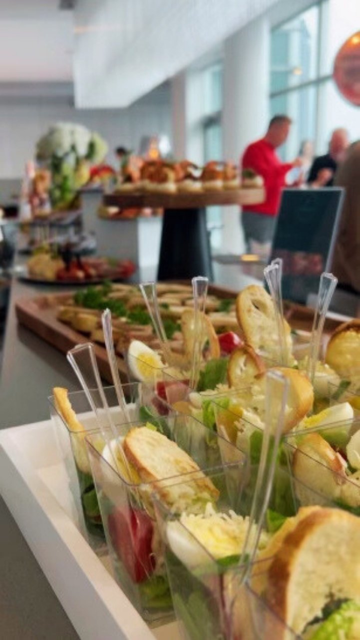 Office lunch catering setup with salads and mains