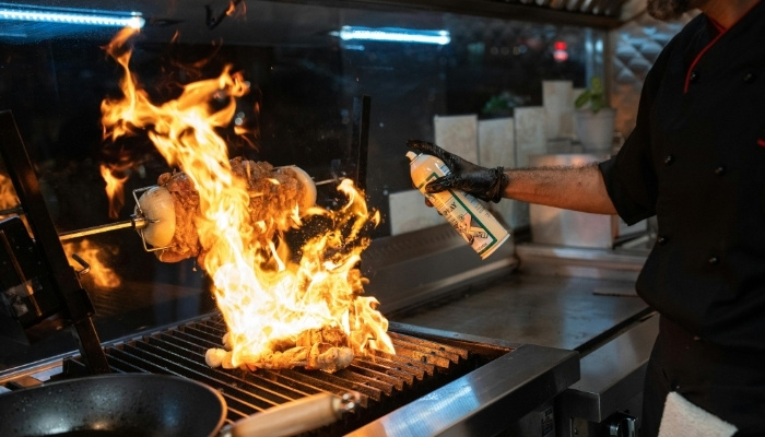 Live grill station with chef carving smoked meats