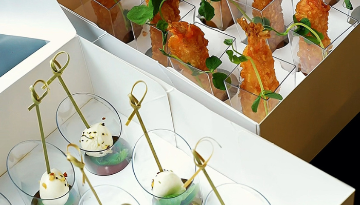 Drop-off catering trays labeled and ready to serve