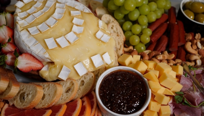 Grazing board with cheeses, charcuterie and fruit for a party